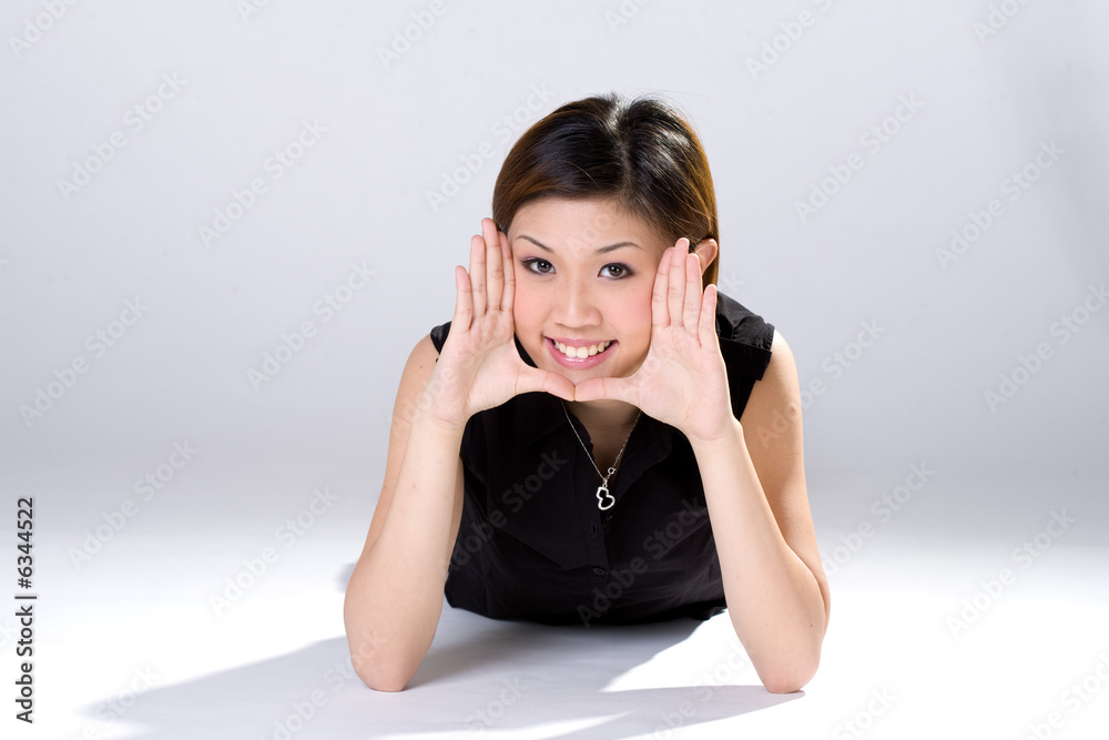 expressive girl with palm out on her face lying on the floor expressive girl with palm out on her face lying on the floor
