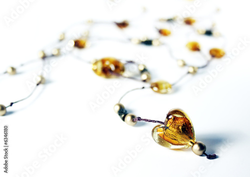 Amber heart on necklace with golden pearls photo