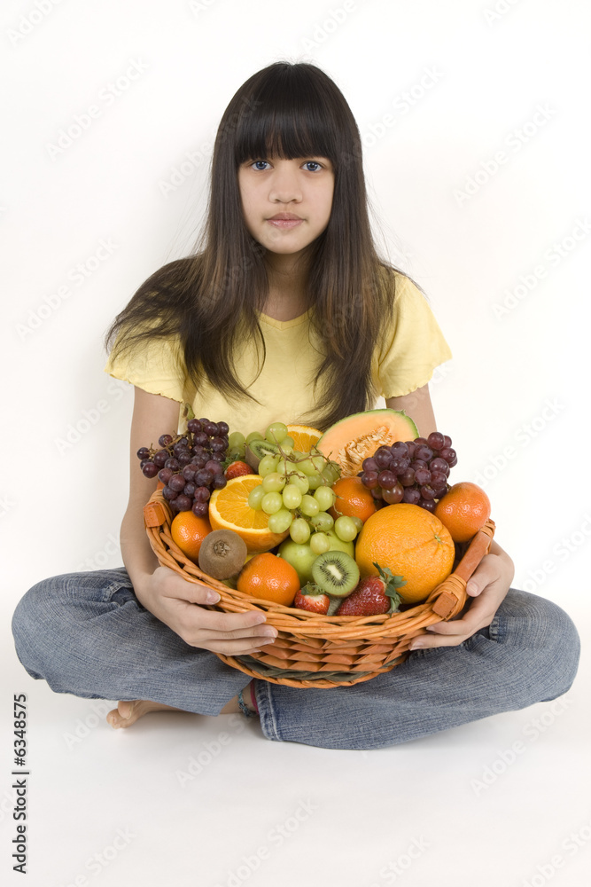 Teenager with fruit basket before white background Teenager with fruit basket before white background