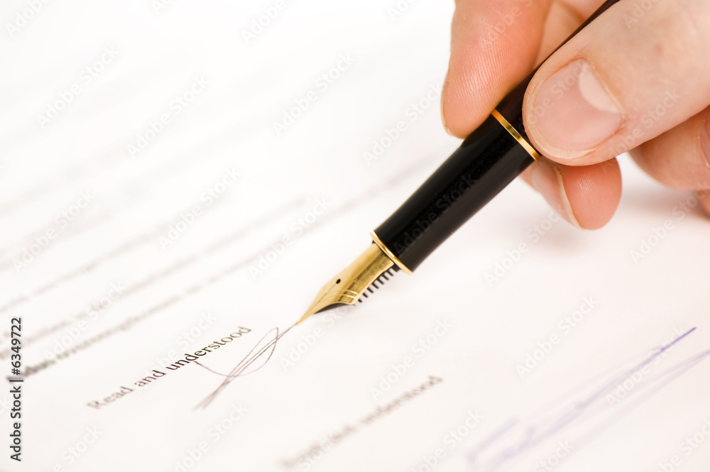 Fototapeta premium someone signing a document with a pen. text is blur. 
