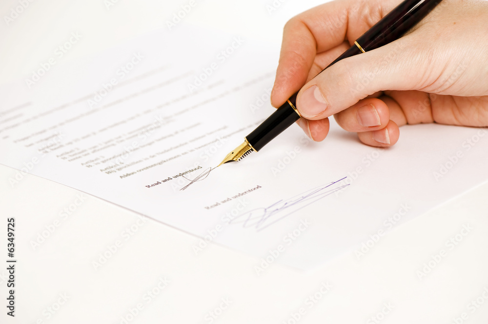 someone signing a document with a pen. text is blur. someone signing a document with a pen. text is blur.