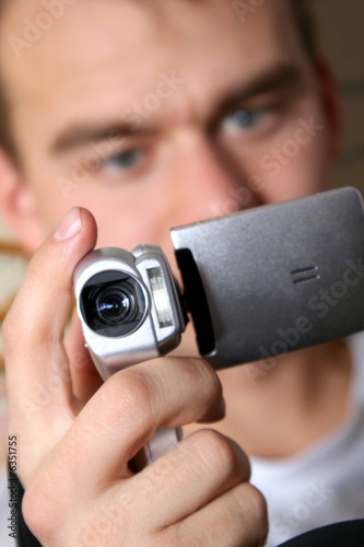 young man with digital video camera