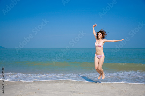woman jumping at the beach