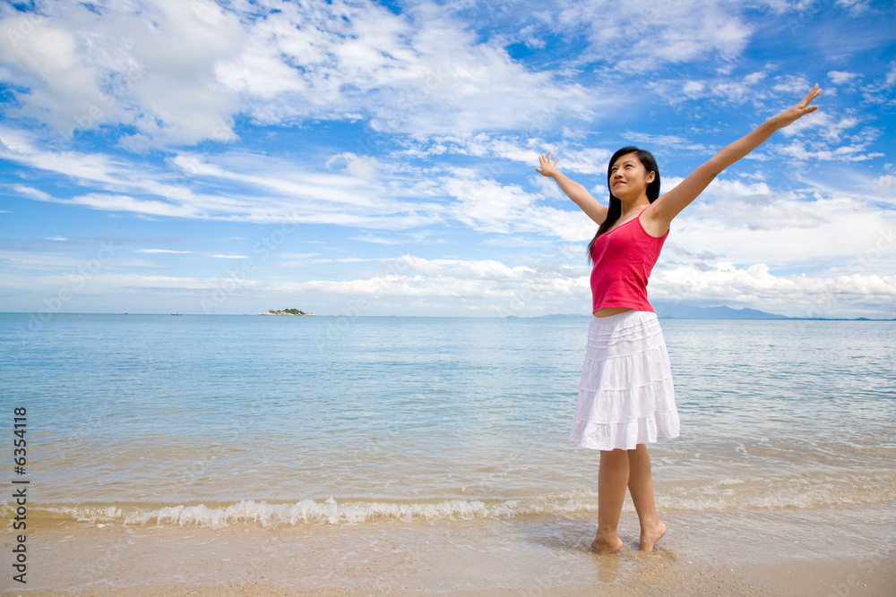 beautiful red top girl & white skirt stretching on the beach beautiful red top girl & white skirt stretching on the beach