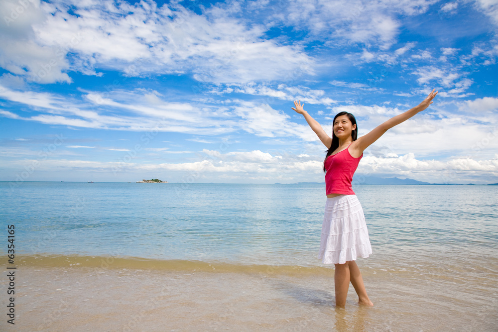 beautiful red top girl & white skirt stretching on the beach beautiful red top girl & white skirt stretching on the beach