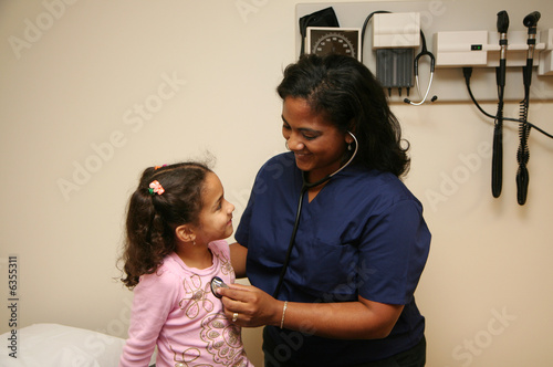 Hispanic nurse checks white...