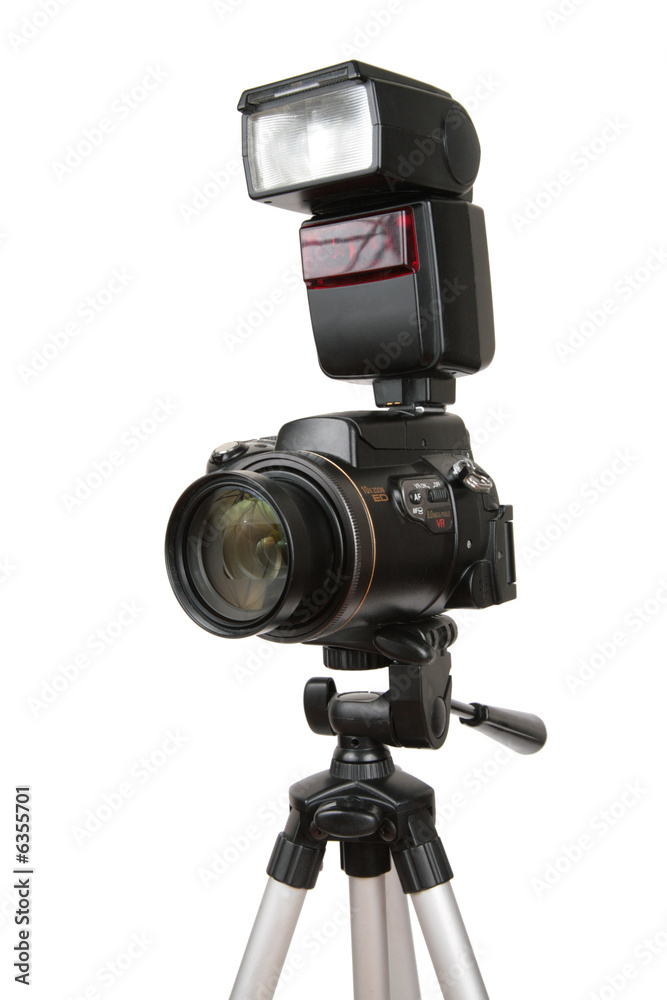 modern photo camera with flash on tripod