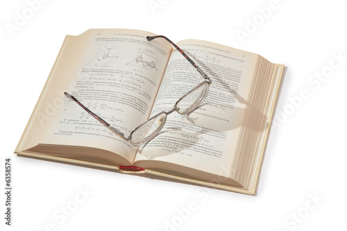 glasses on opening textbook