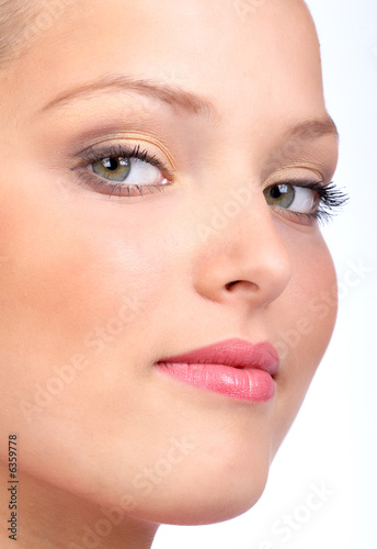Beautiful young woman face. Over white background.
