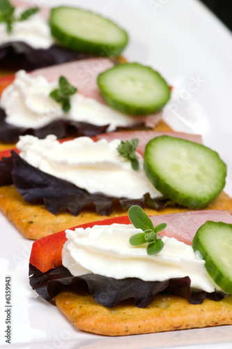 crackers with cream cheese, ham, bell pepper, cucumber 