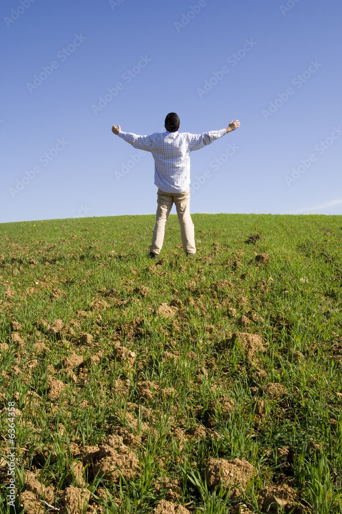 man outstretched to the blue sky (with copyspace) man outstretched to the blue sky (with copyspace)