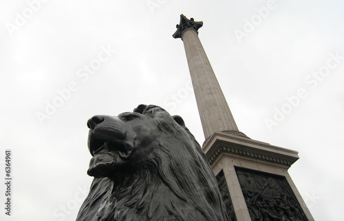 London, Stone lion and column of Nelson at Trafalgar Square photo