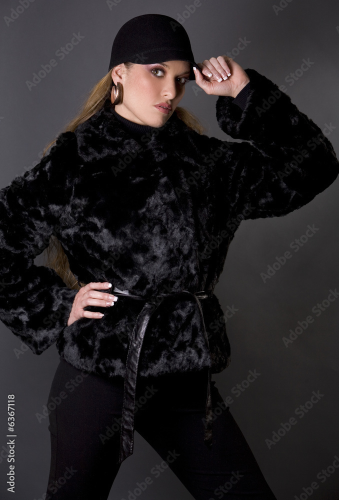 pretty model wearing black fur coat and black pants