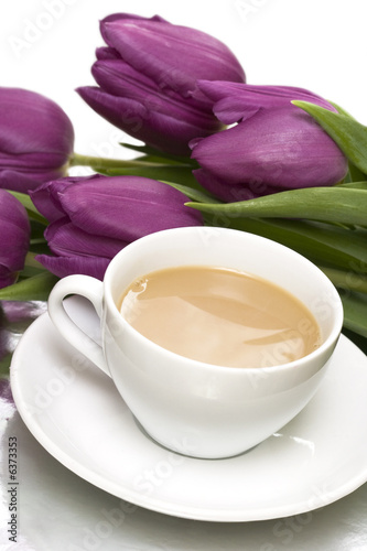 white cup of coffee with violet tulips