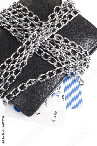 wallet and credit card tied with chain on white background