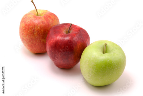 green and two red apples, isolated