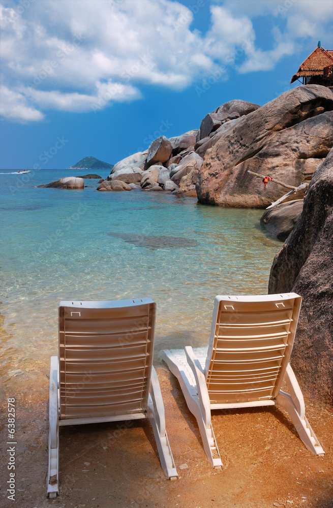 Fototapeta premium Two sunbeds on a private beach