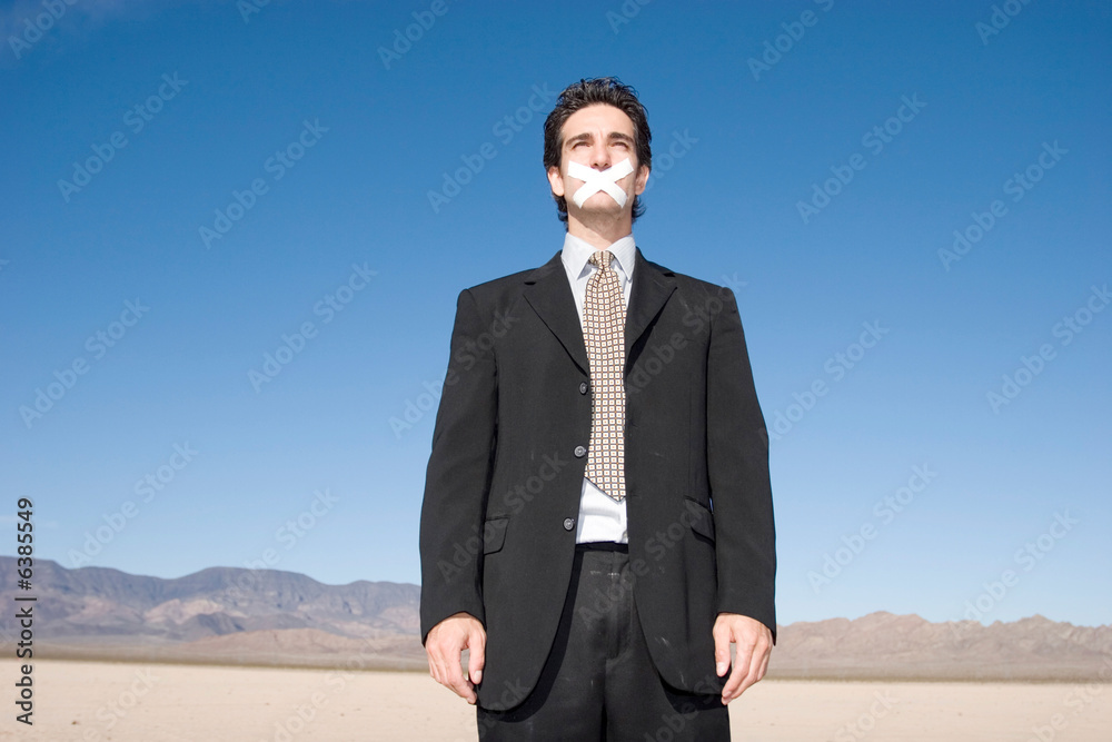 Businessman with a duct tape on his mouth Businessman with a duct tape on his mouth