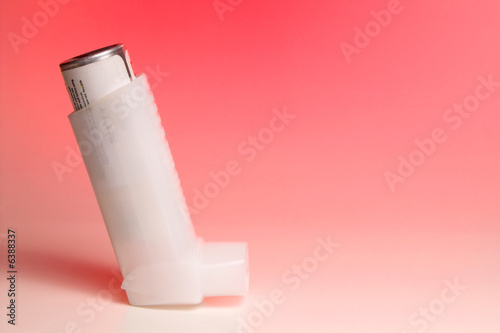 A medicated inhaler used for asthma attacks. photo