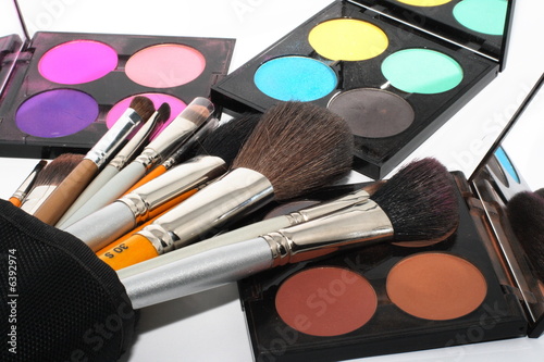 Set of different brushes near set of cosmetics