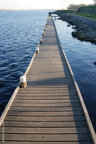 Family with children walking on a pier