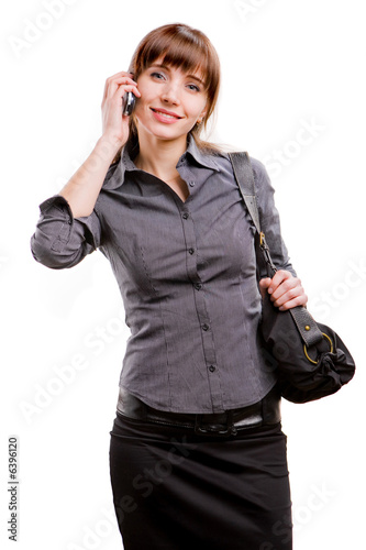 young smiling successful business woman speaks by a mobile phone