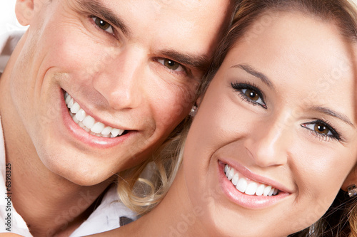Young love couple smiling. Over white background  .