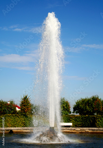 fountain in the garden, red roof and blue sky