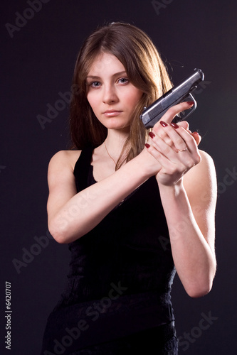 lady in black handing pistol.