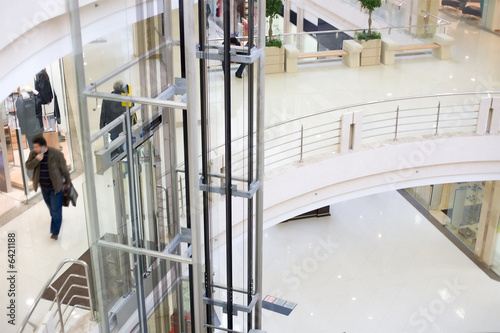 Modern glass elevator in the mall