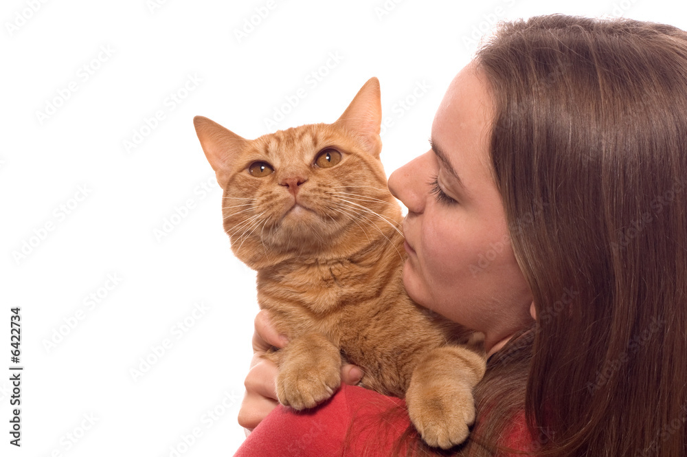 A teenaged girl holds her pet cat