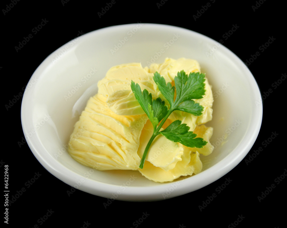 Fresh butter sculpted with parsley in a dish. Fresh butter sculpted with parsley in a dish.