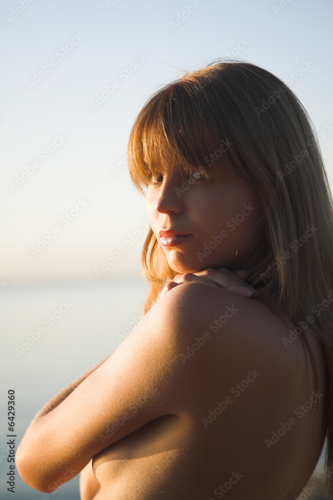 young topless girl on the evening beach young topless girl on the evening beach