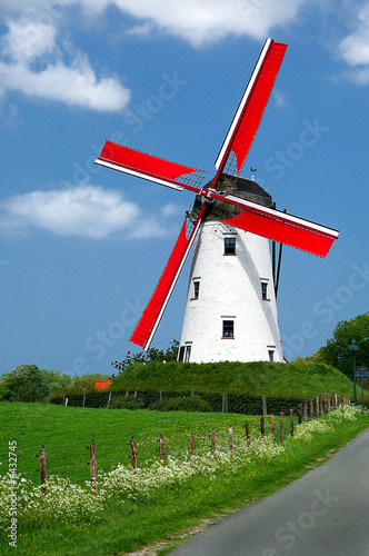 Traditional windmill with red vanes in the Holland countryside