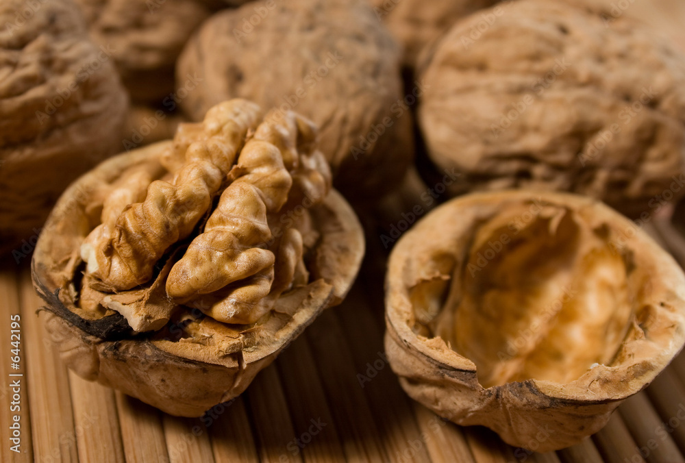 Halved walnut with other walnuts in background Halved walnut with other walnuts in background