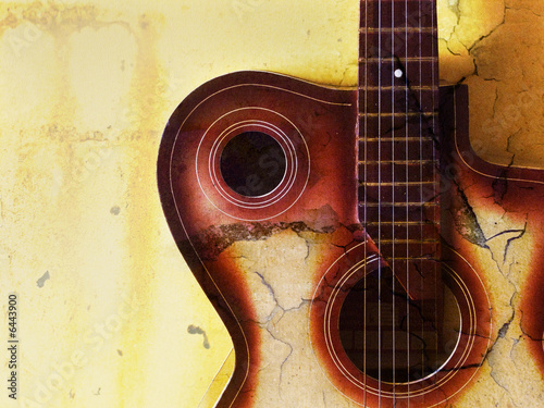 vintage grunge background with guitar on wall