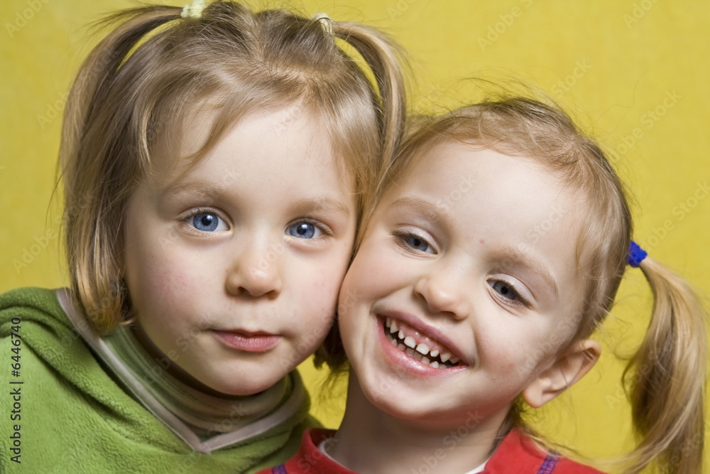 Portrait of happy children on a yellow background Portrait of happy children on a yellow background