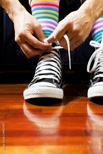 Close up of a teenager tying his footwear