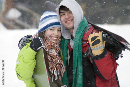 A lifestyle image of two teens snowboarders in snow