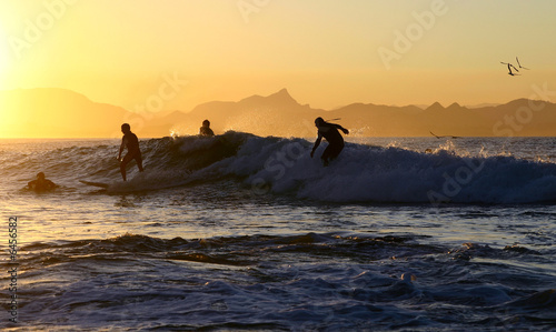 four surfers on one wave