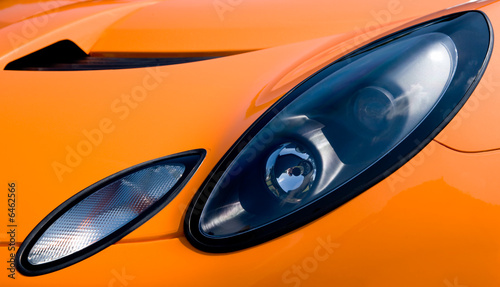 Headlight and hood of asportscar conveys a feeling of  power © Howard