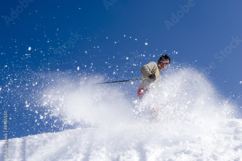 Snow Skier Jumping Against Blue Sky