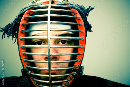martial arts concept portrait.Man in kendo helmet