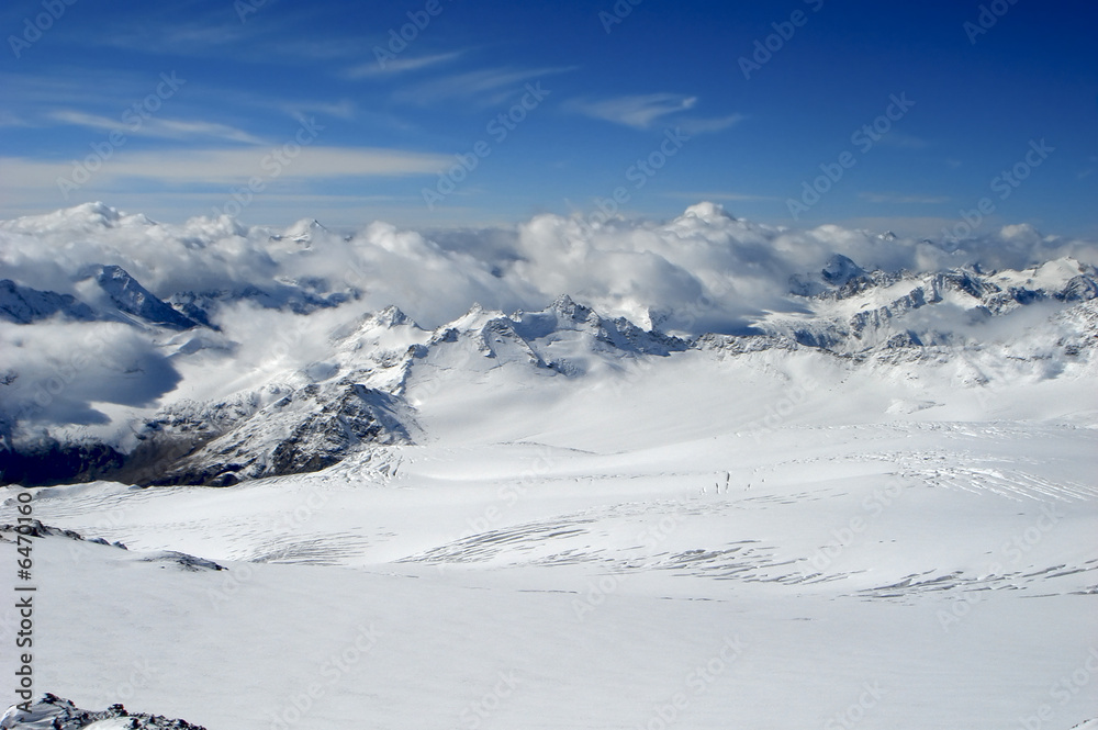 Snow-covered tops  on a background of the blue sky