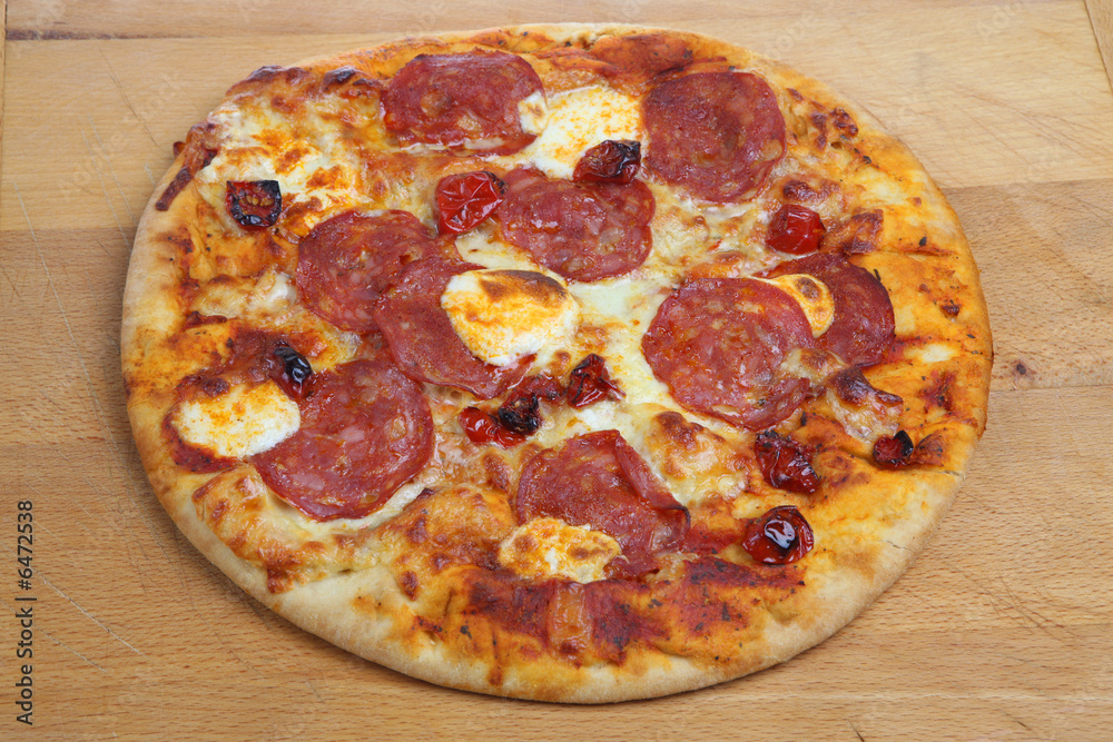 Pizza with salami, sun-dried tomatoes and cheese Pizza with salami, sun-dried tomatoes and cheese