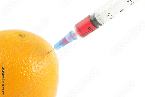 Syringe injecting in orange