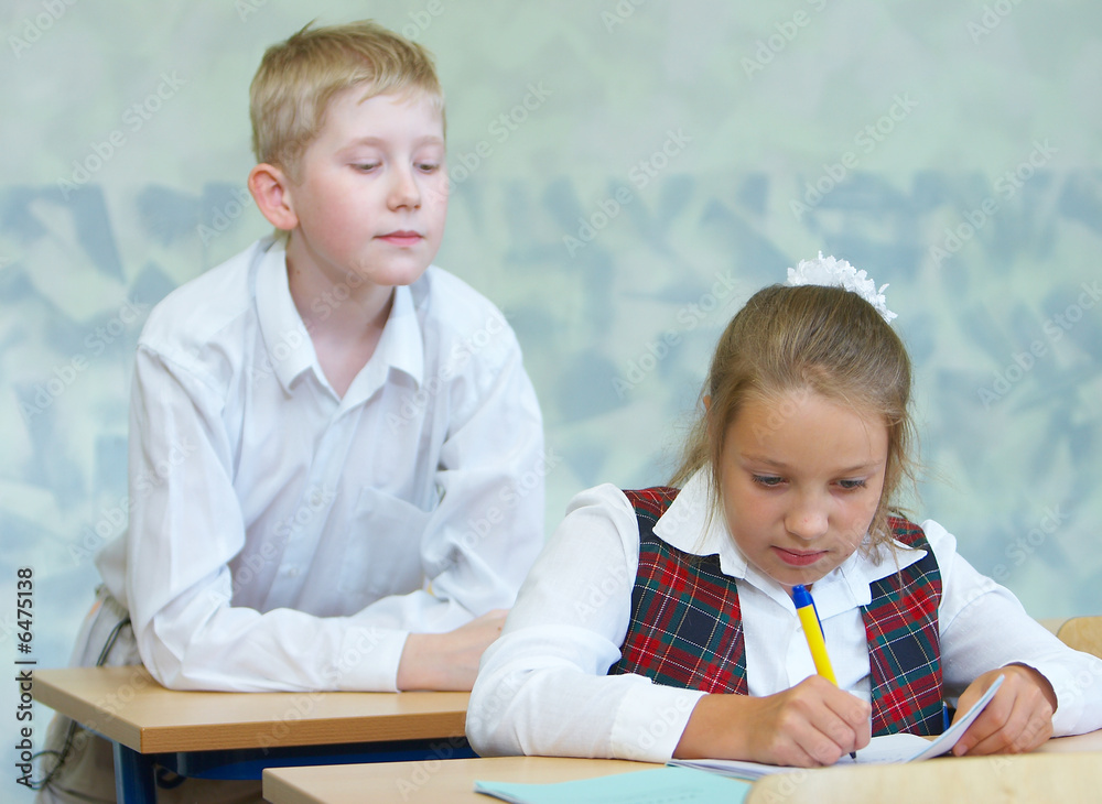 The boy tries to peep that the girl writes The boy tries to peep that the girl writes