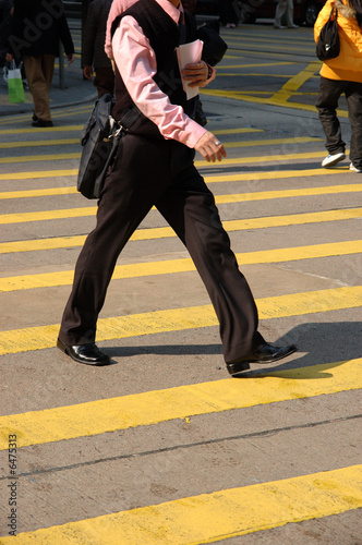Business man crossing street in the city