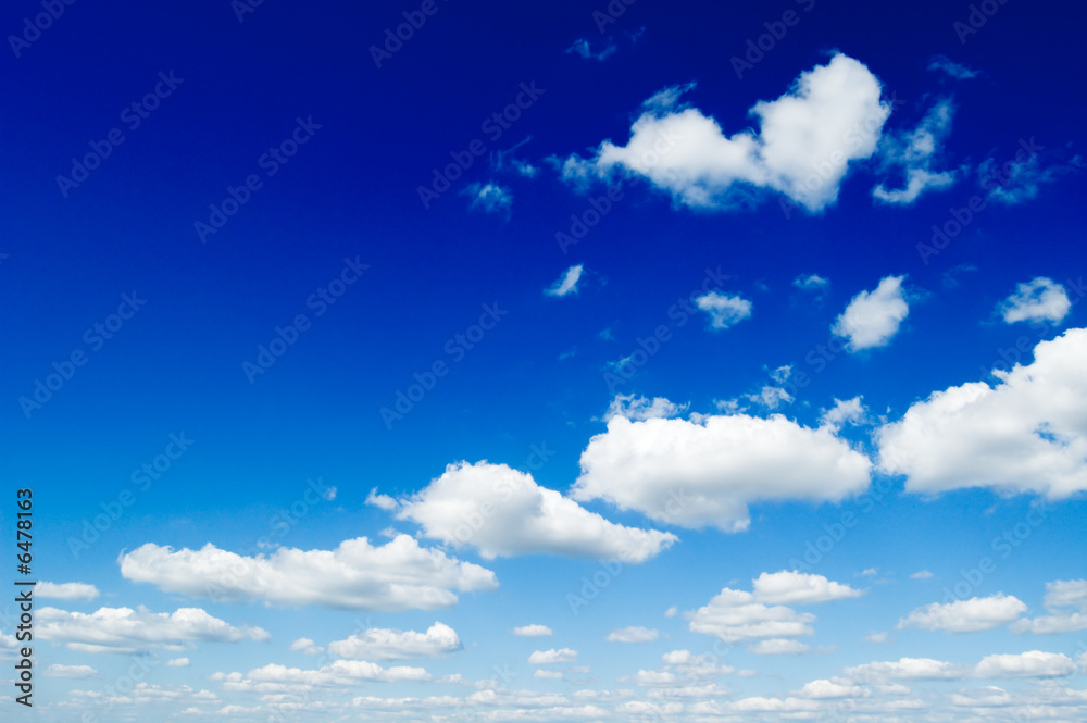 blue sky is covered by white fluffy clouds. blue sky is covered by white fluffy clouds.