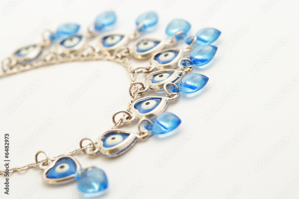 Obraz premium Blue necklace on white